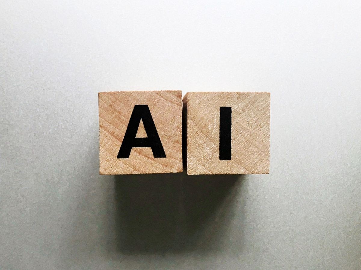 Word AI or Artificial Intelligence concept,  written with wood cubes